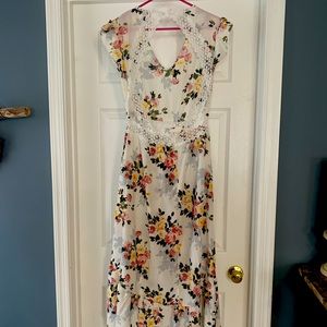 cream floral dress w/ lace embellishments. Front length is 42” & back is 54”.